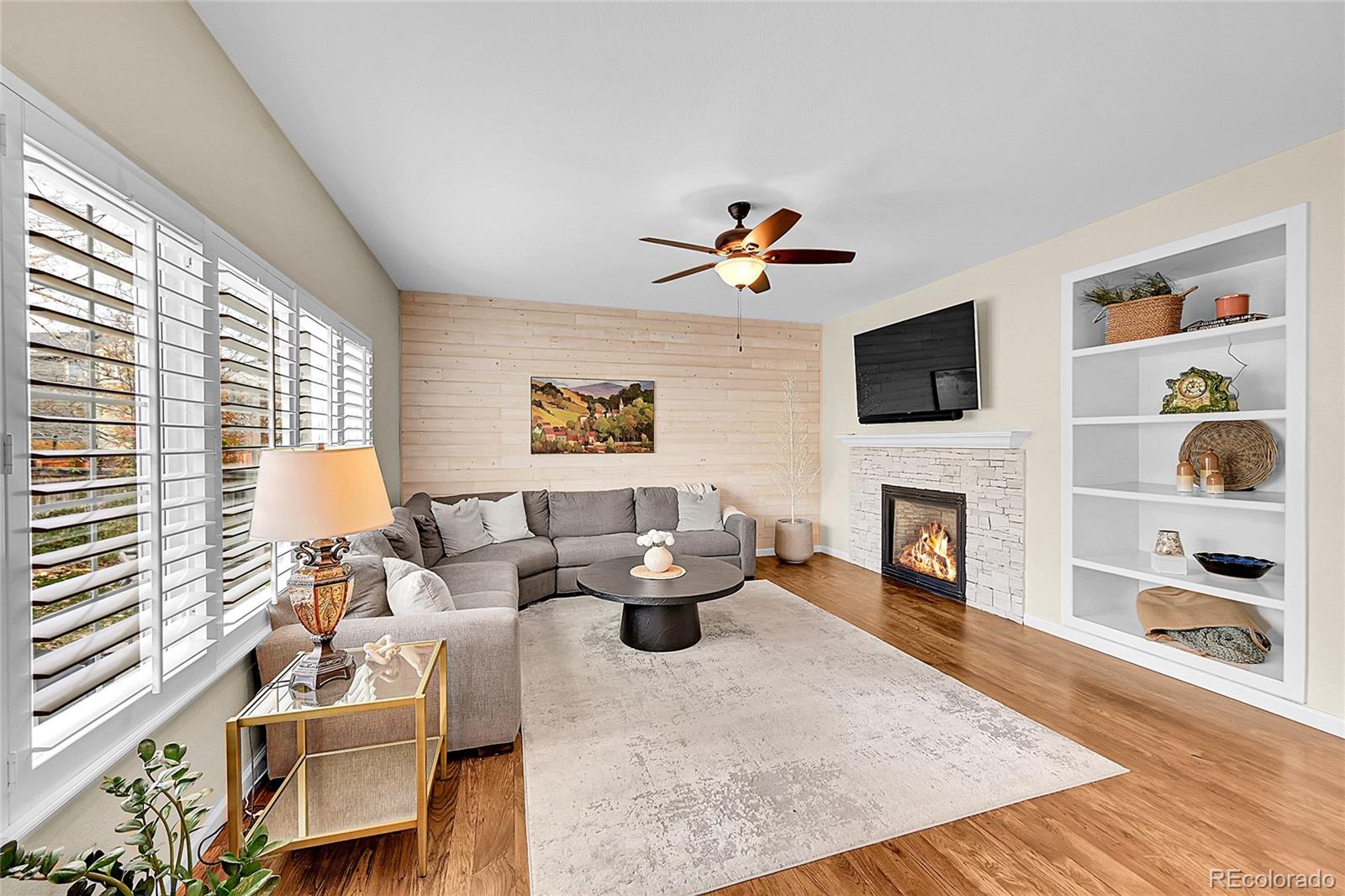 9424 South Hackberry Lane Highlands Ranch, CO 80129 - Photo 17 of 47 a living room with furniture and a fireplace