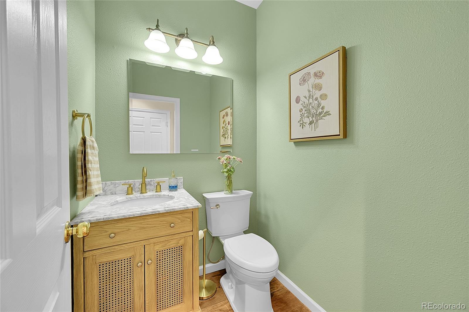 9424 South Hackberry Lane Highlands Ranch, CO 80129 - Photo 19 of 47 a bathroom with a granite countertop toilet sink and mirror