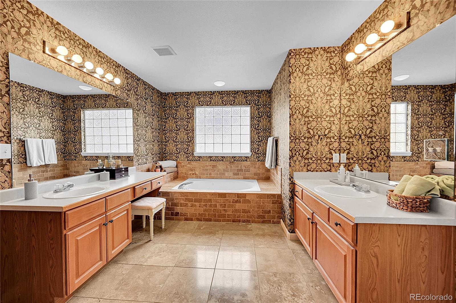9424 South Hackberry Lane Highlands Ranch, CO 80129 - Photo 23 of 47 a bathroom with a tub sink and mirror