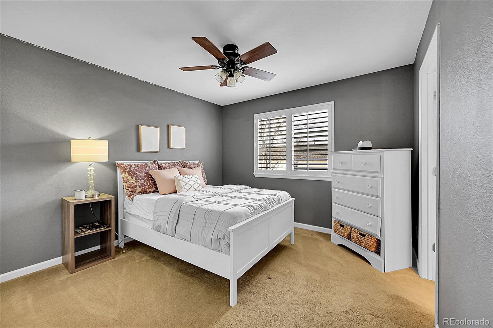 9424 South Hackberry Lane Highlands Ranch, CO 80129 - Photo 25 of 47 a bedroom with a bed and a ceiling fan