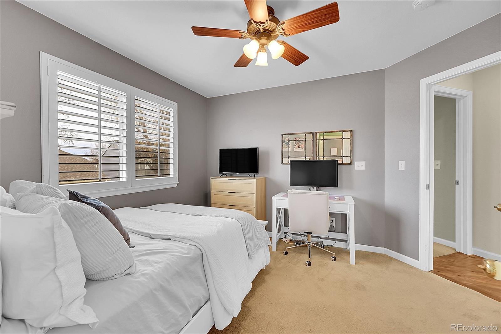 9424 South Hackberry Lane Highlands Ranch, CO 80129 - Photo 28 of 47 a bedroom with a bed and a chair