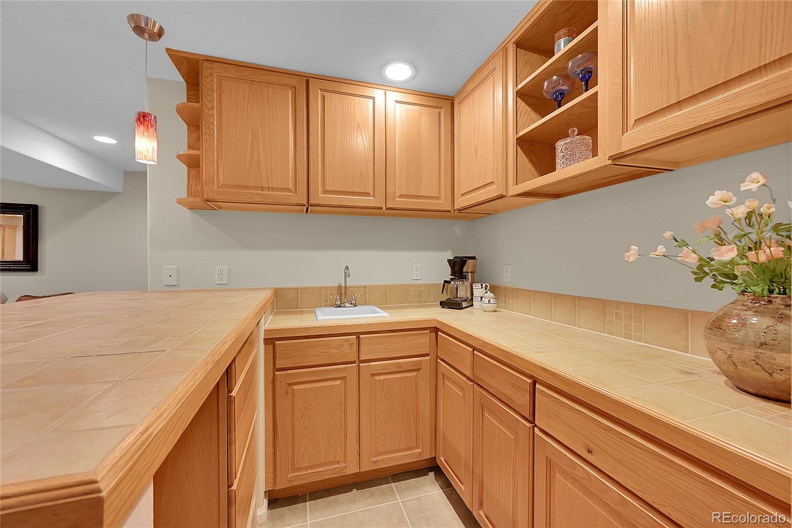9424 South Hackberry Lane Highlands Ranch, CO 80129 - Photo 36 of 47 a kitchen with a sink and cabinets