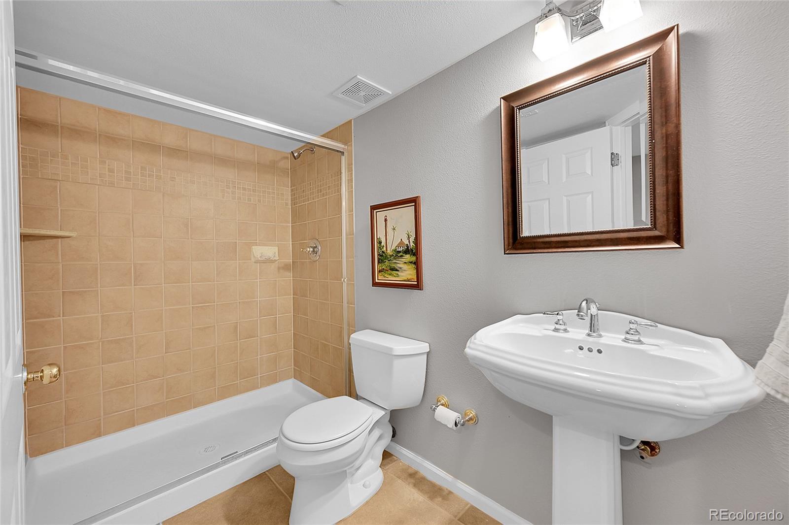 9424 South Hackberry Lane Highlands Ranch, CO 80129 - Photo 39 of 47 a bathroom with a toilet sink and mirror
