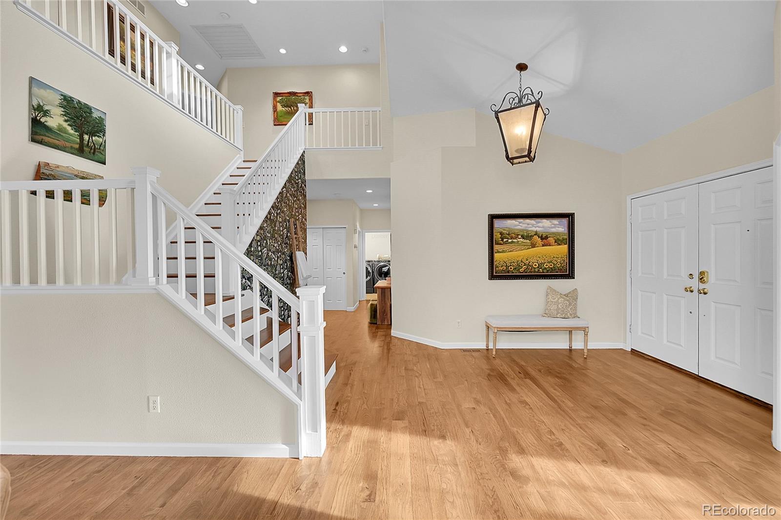 9424 South Hackberry Lane Highlands Ranch, CO 80129 - Photo 4 of 47 a view of a hallway with wooden floor and stairs