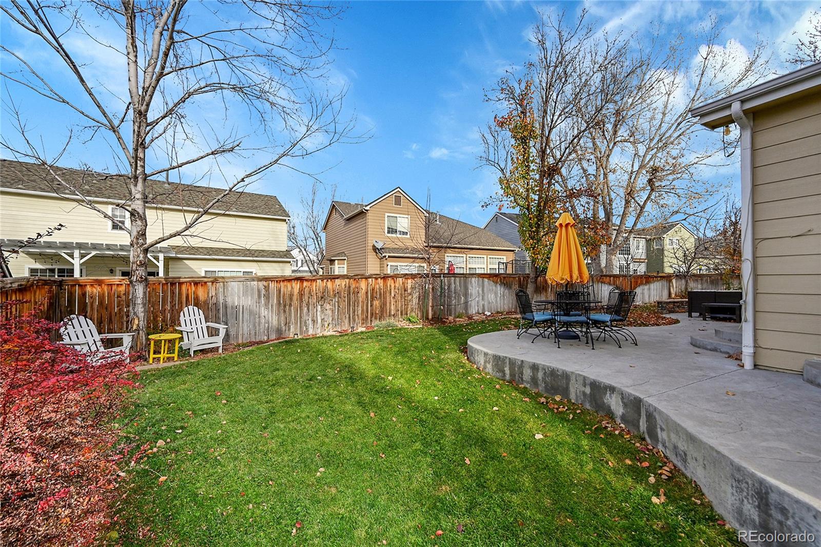 9424 South Hackberry Lane Highlands Ranch, CO 80129 - Photo 43 of 47 a view of a house with backyard and a tree