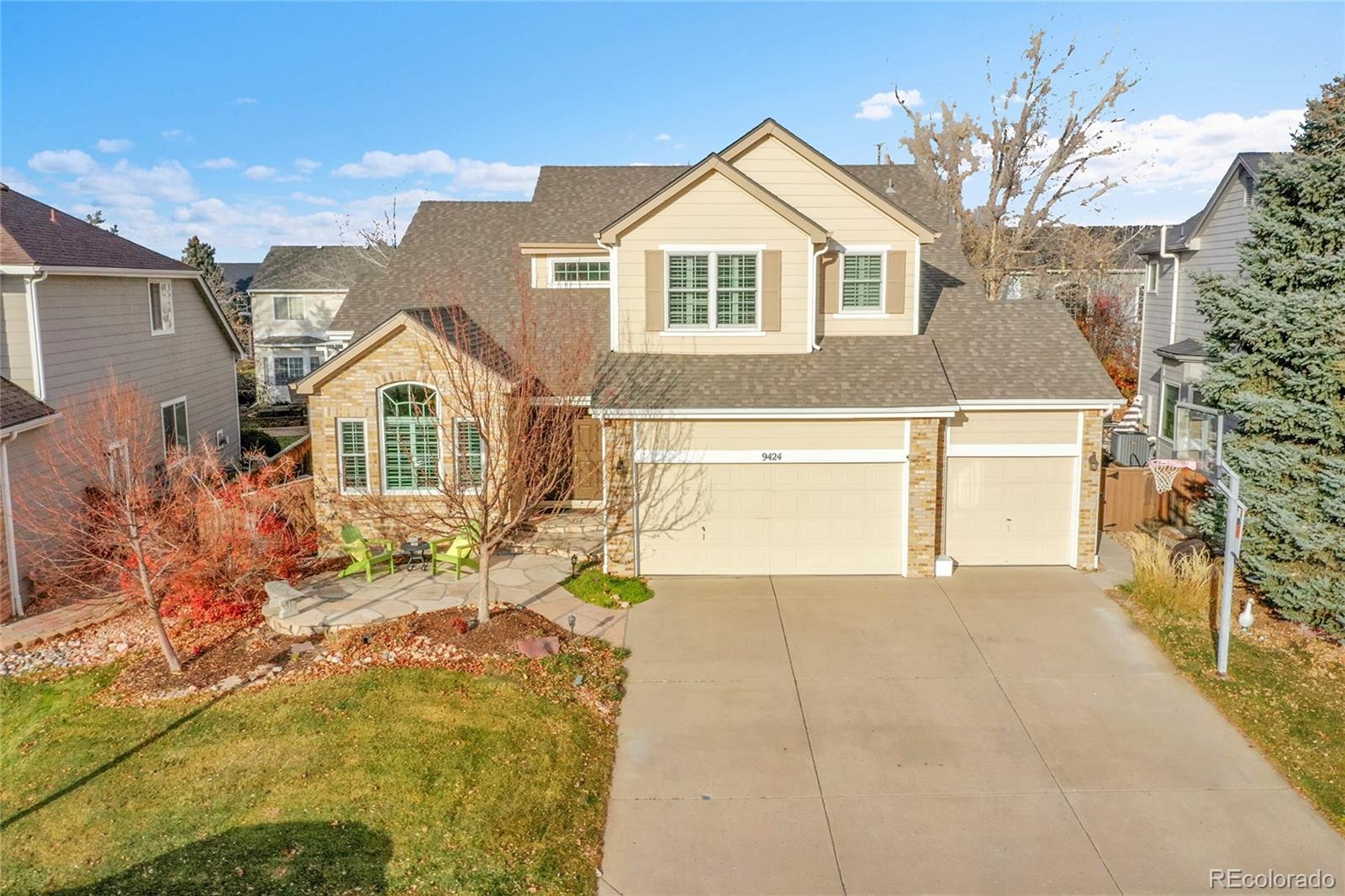 9424 South Hackberry Lane Highlands Ranch, CO 80129 - Photo 44 of 47 a front view of a house with a yard and garage