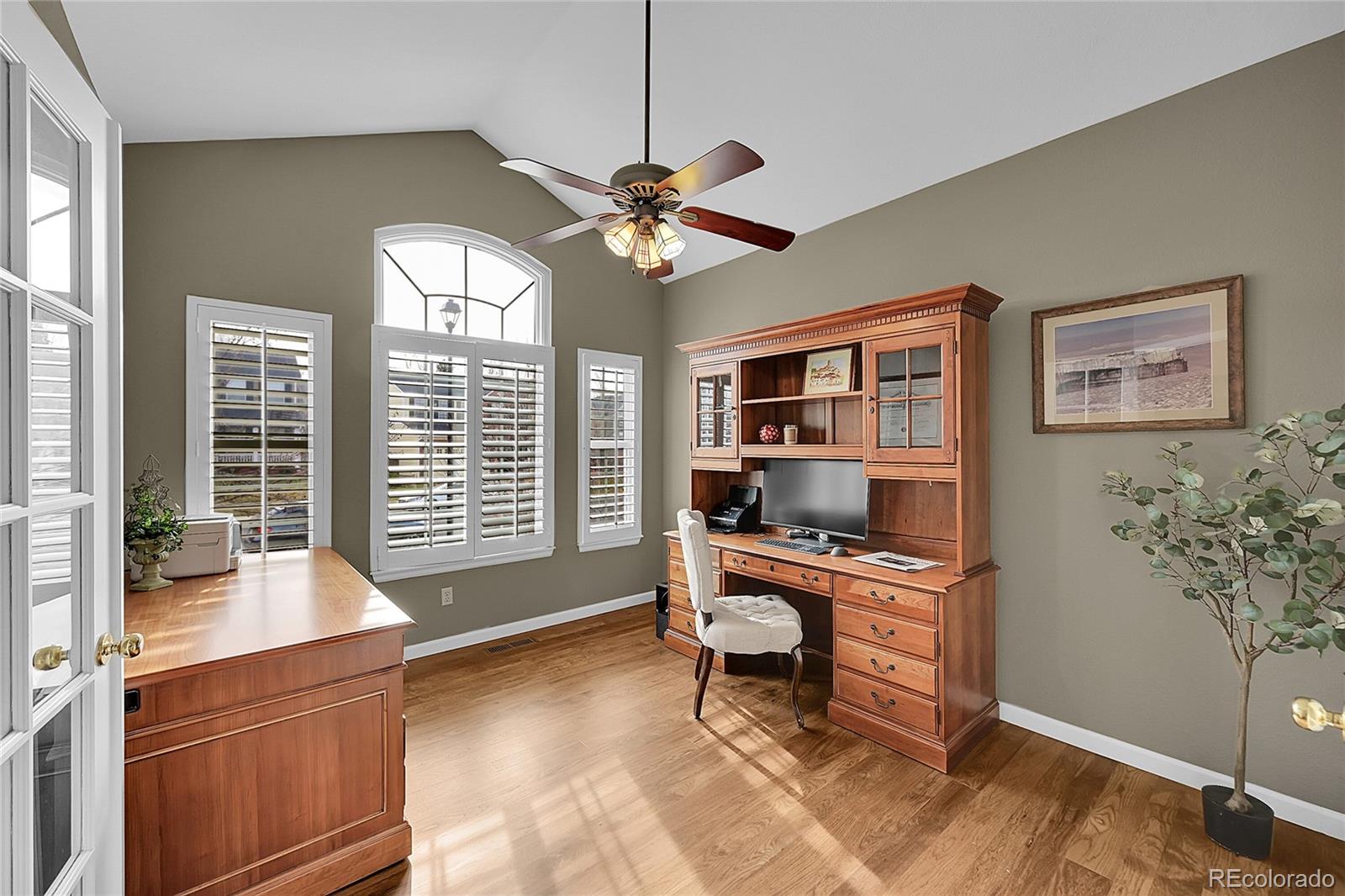 9424 South Hackberry Lane Highlands Ranch, CO 80129 - Photo 7 of 47 a workspace with wooden floor and a window