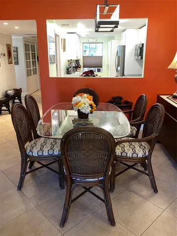 a kitchen with a wooden table and chairs