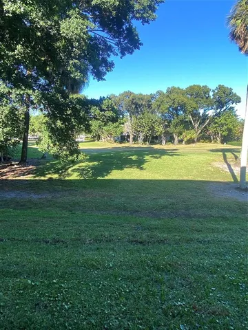 a view of a field with an ocean view