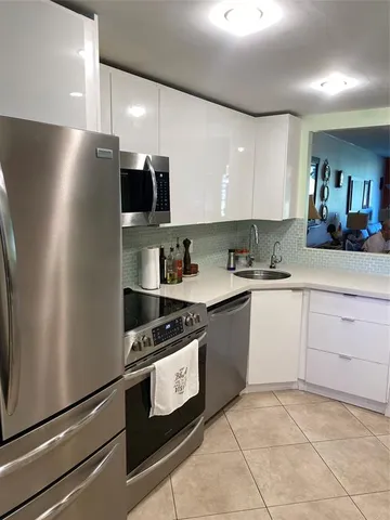 a kitchen with refrigerator and microwave