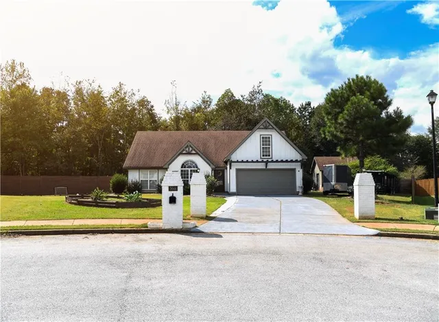 a view of backyard with swimming pool and seating space