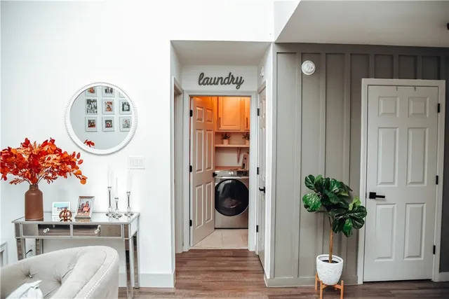 a view of a hallway with entryway wooden floor and a potted plant