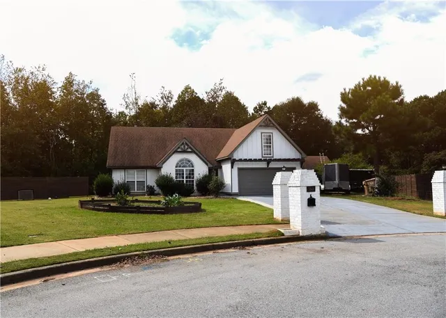 a front view of a house with a yard and garage