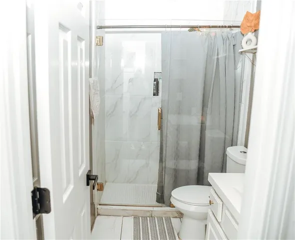 a bathroom with a shower and a toilet