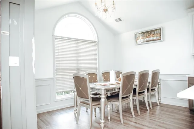 a view of a dining room with furniture and wooden floor