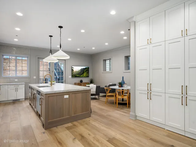 a view of living room kitchen with furniture and wooden floor