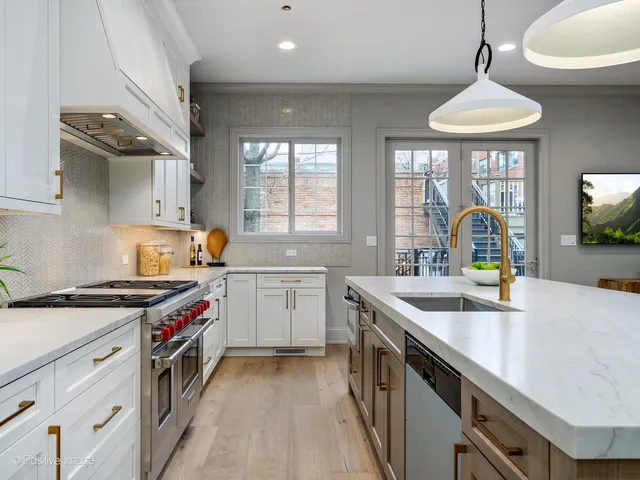 a kitchen with a stove a sink and a window