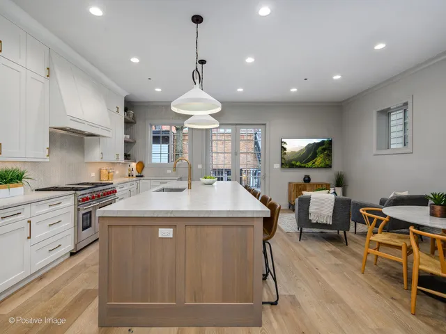 a kitchen with stainless steel appliances granite countertop a sink a stove and a refrigerator