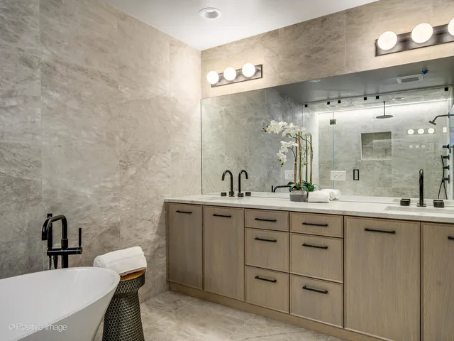 a bathroom with a double vanity sink and a mirror