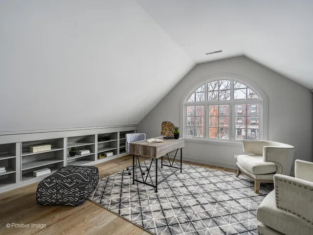 a living room with furniture a rug and a window