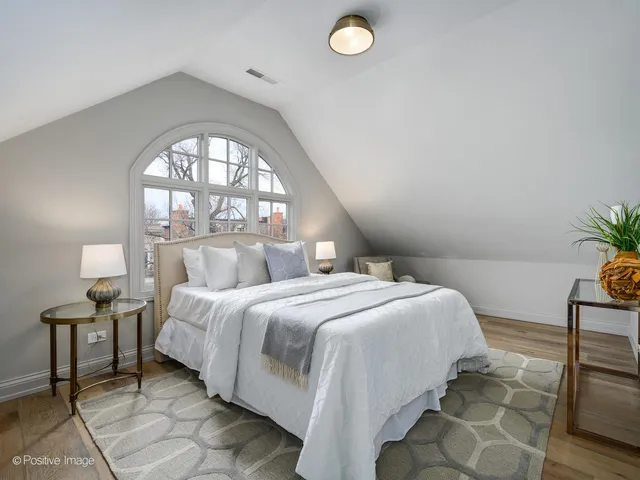 a bedroom with a bed and a potted plant