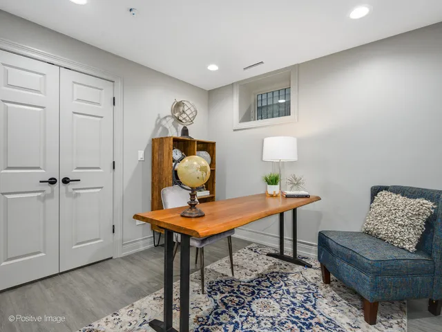 a workspace room with furniture and wooden floor