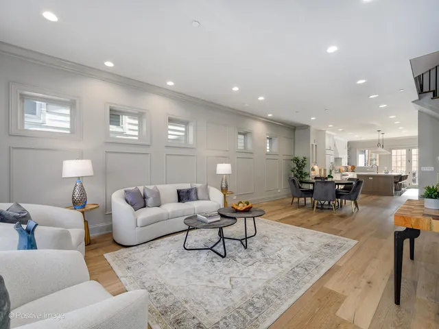 a living room with furniture and kitchen view