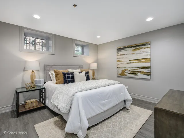 a bedroom with a bed and a night stand