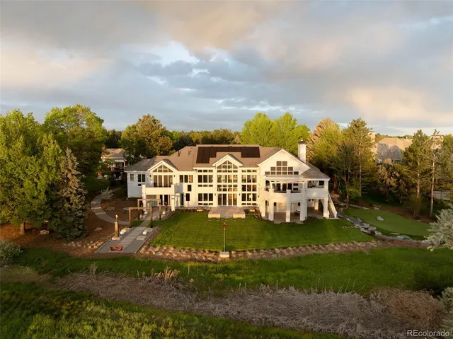 aerial view of a house with a big yard and large trees