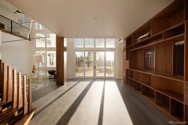 a view of a room with wooden floor and windows