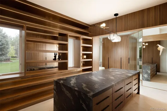 a bathroom with a sink a large mirror and vanity