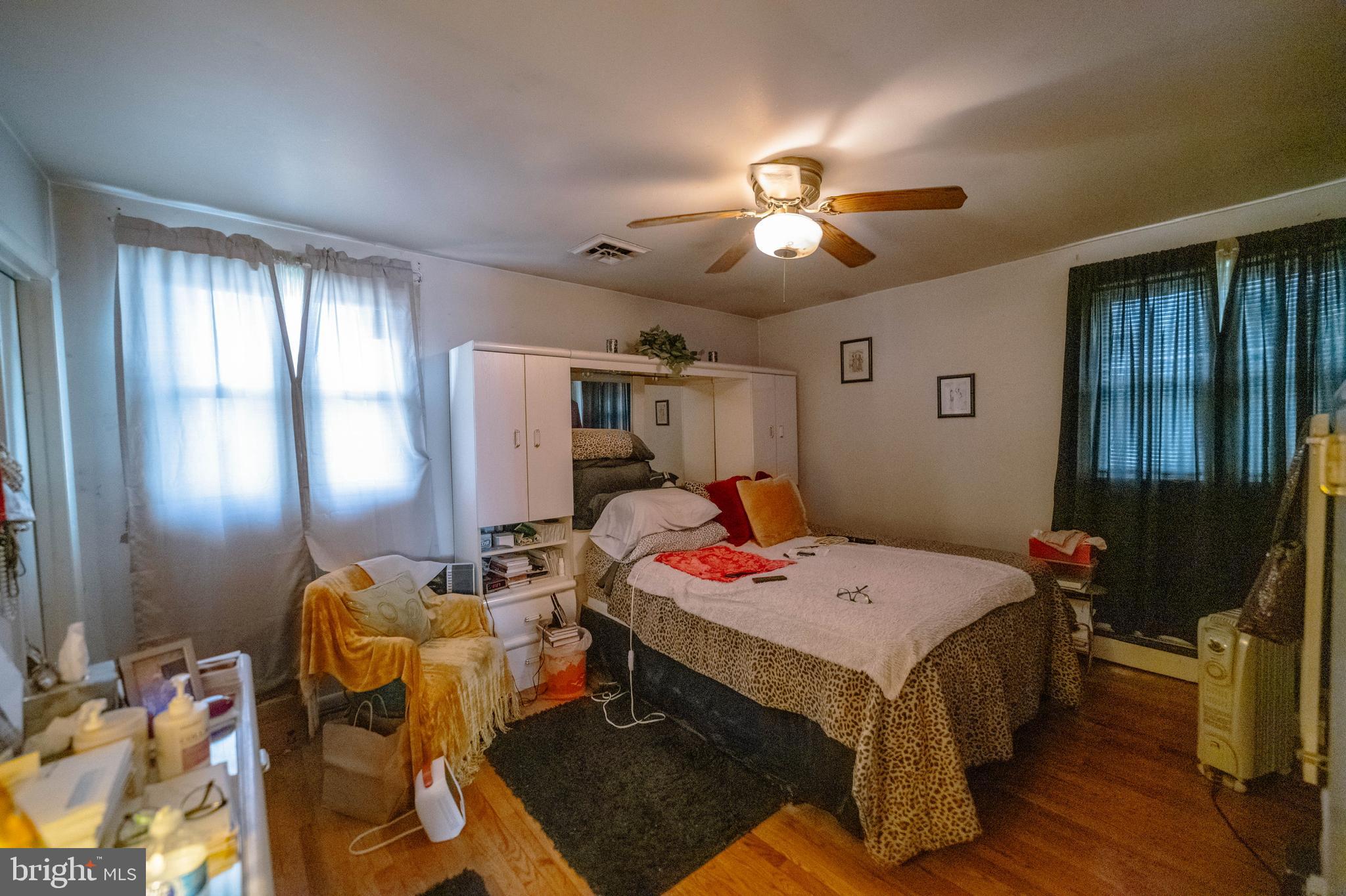 6900 Temple Hill Road Temple Hills, MD 20748 - Photo 30 of 43 a bed room with a bed and a chandelier