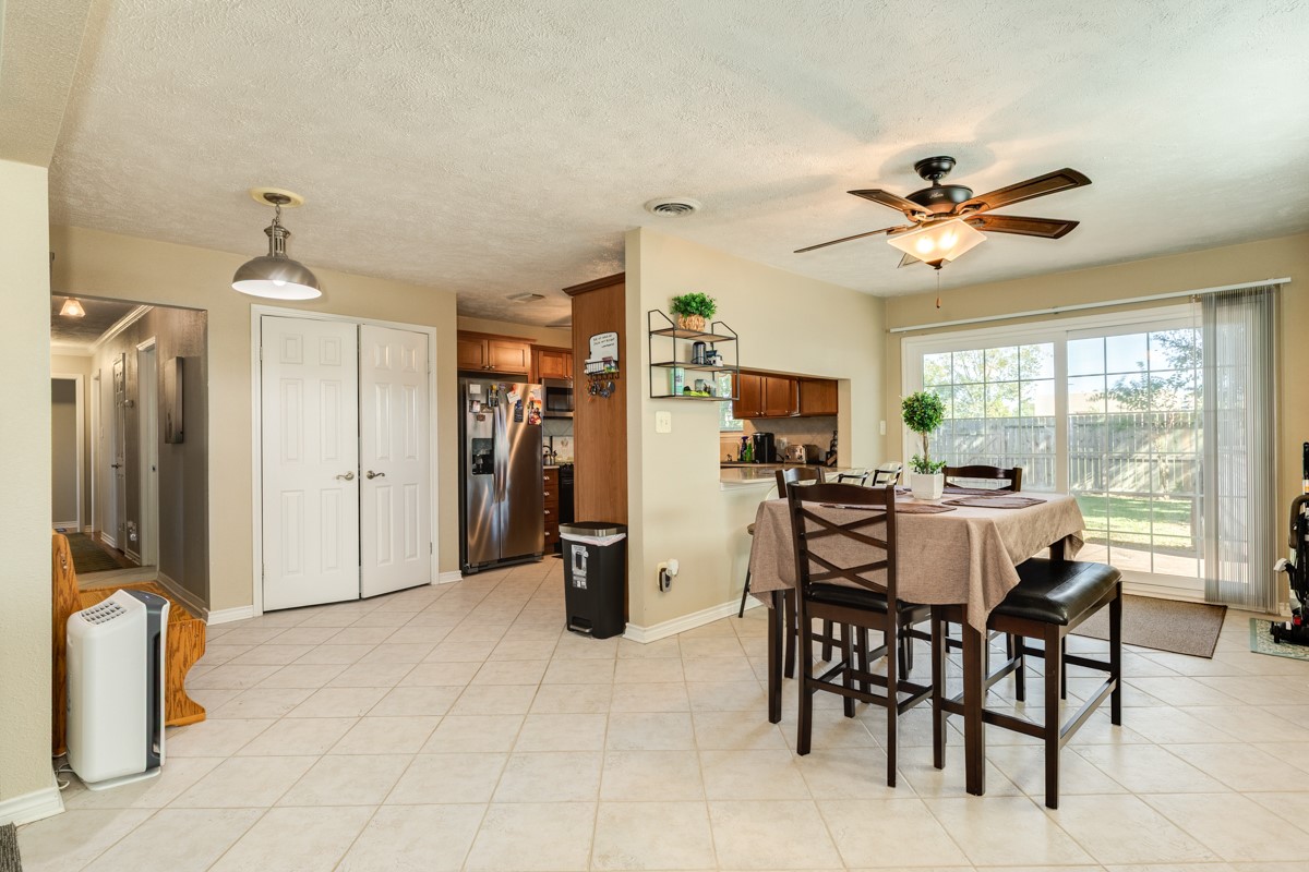 820 Perry Street Angleton, TX 77515 - Photo 14 of 26 a view of a dining room with furniture and a chandelier
