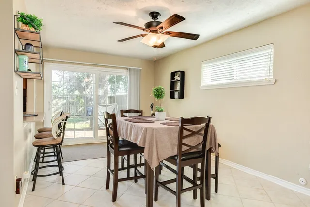 a dining room with furniture and window