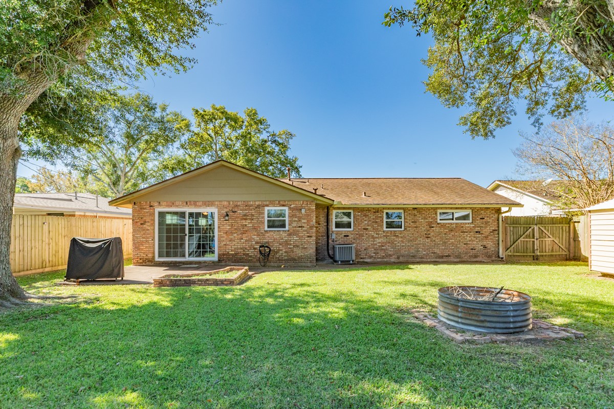 820 Perry Street Angleton, TX 77515 - Photo 5 of 26 a front view of a house with a yard and garage