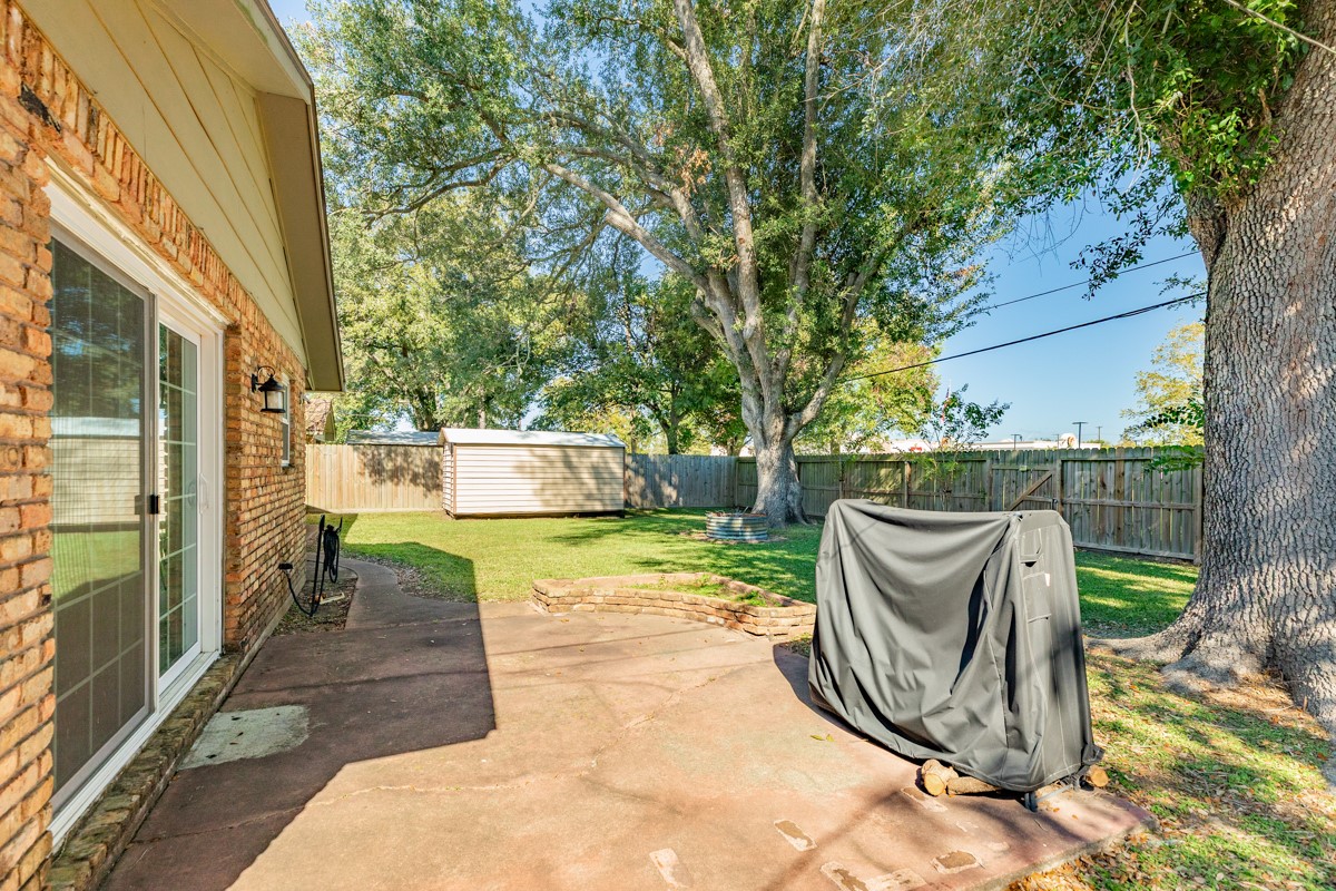 820 Perry Street Angleton, TX 77515 - Photo 6 of 26 a view of a chair and table in the patio