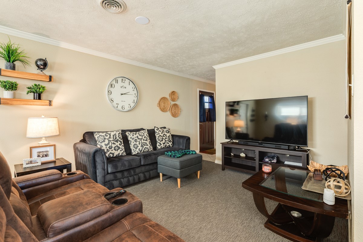 820 Perry Street Angleton, TX 77515 - Photo 9 of 26 a living room with furniture and a flat screen tv