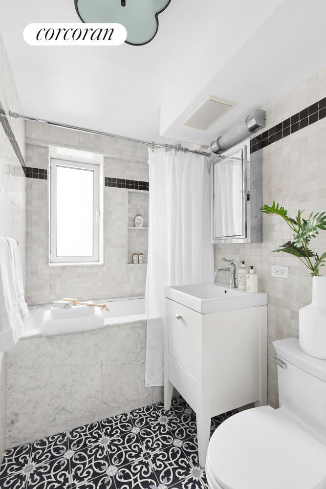 505 East 79th Street, Unit 19B Manhattan, NY 10075 - Photo 10 of 19 a bathroom with a sink a toilet and shower