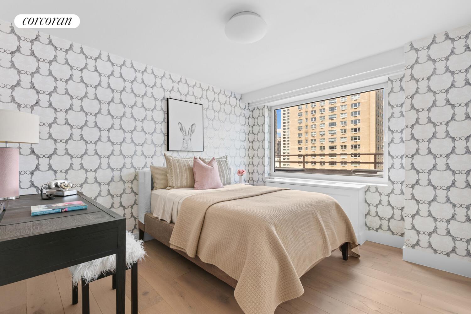 505 East 79th Street, Unit 19B Manhattan, NY 10075 - Photo 11 of 19 a bedroom with a bed and a chair