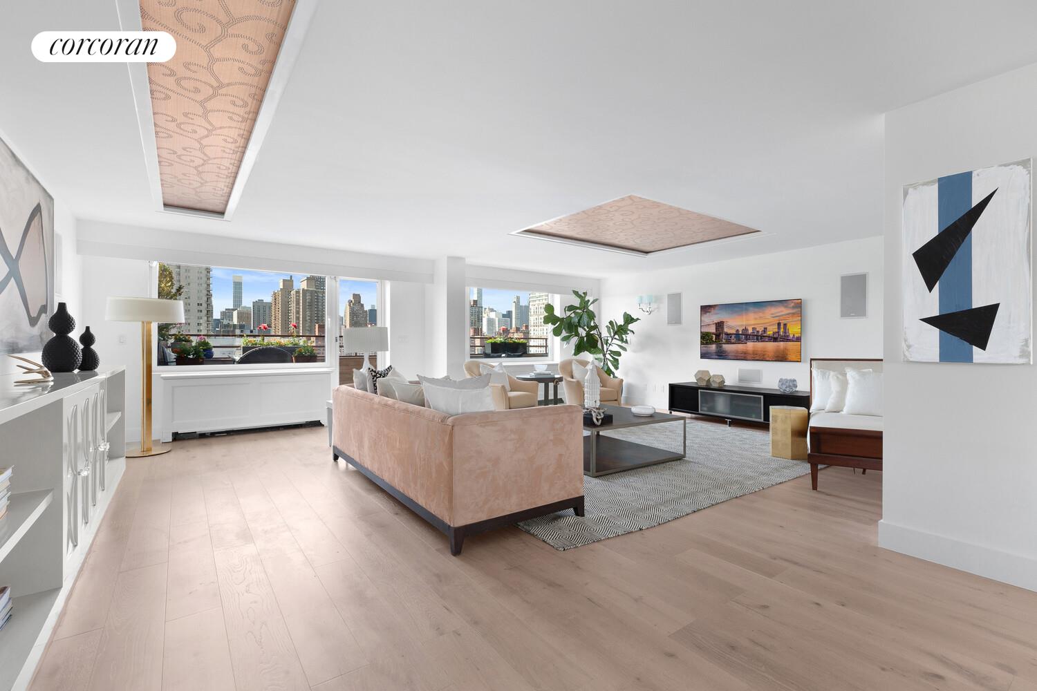 505 East 79th Street, Unit 19B Manhattan, NY 10075 - Photo 2 of 19 a living room with furniture and a flat screen tv