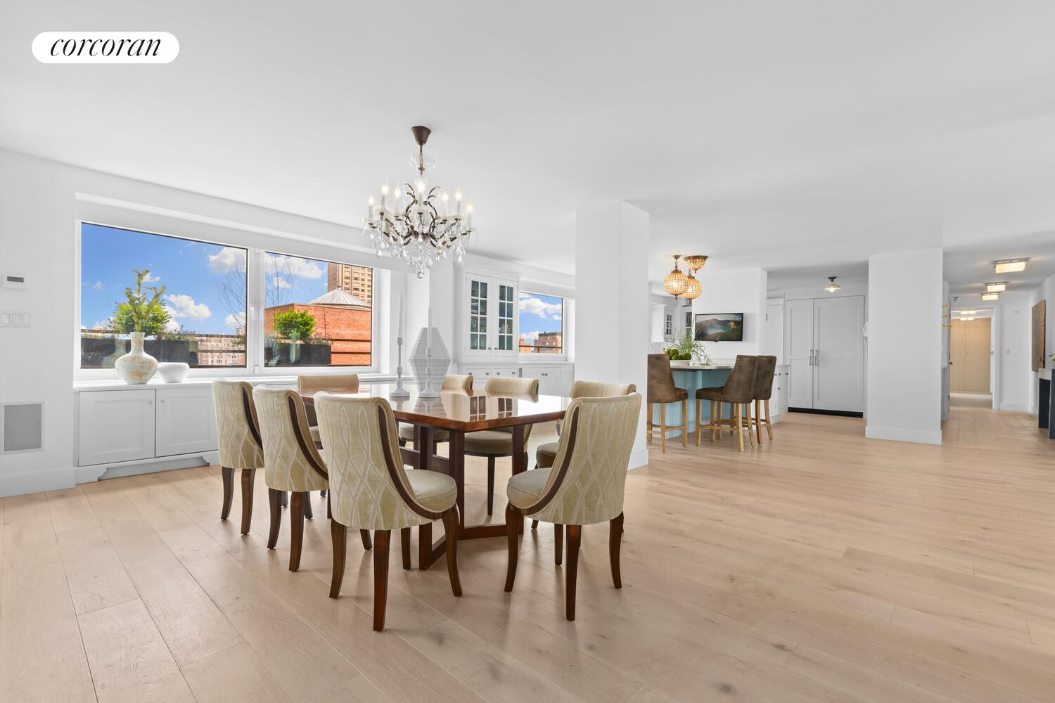 505 East 79th Street, Unit 19B Manhattan, NY 10075 - Photo 5 of 19 a dining room with furniture a chandelier and window