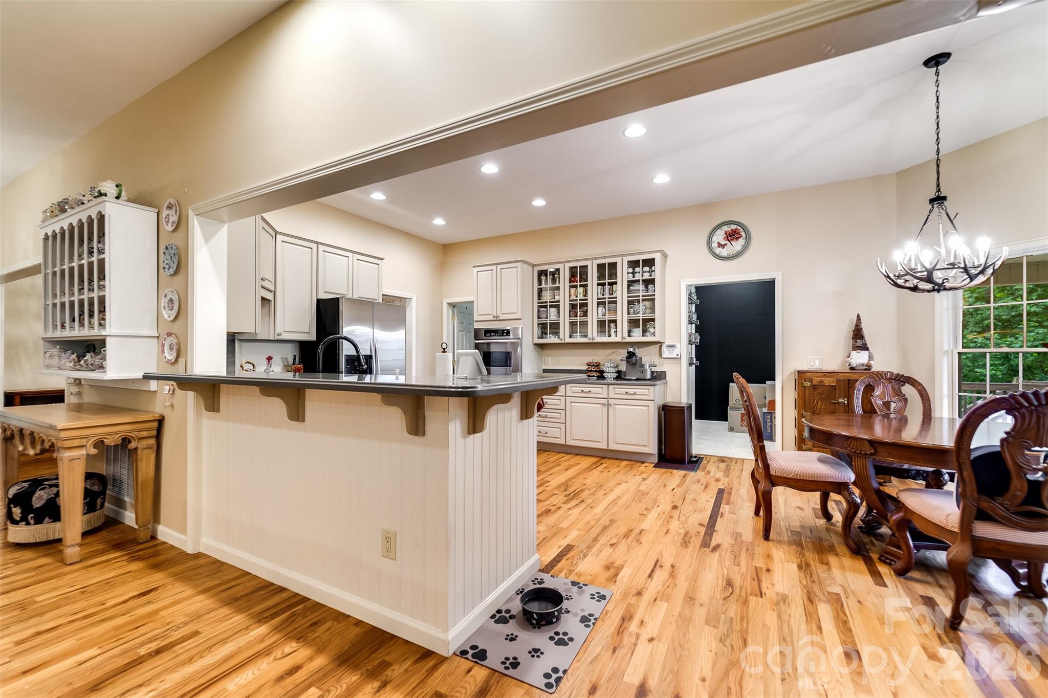 1838 Coman Road Franklin, NC 28734 - Photo 19 of 48 a kitchen with stainless steel appliances kitchen island granite countertop a refrigerator a stove top oven and a dining table with wooden floor