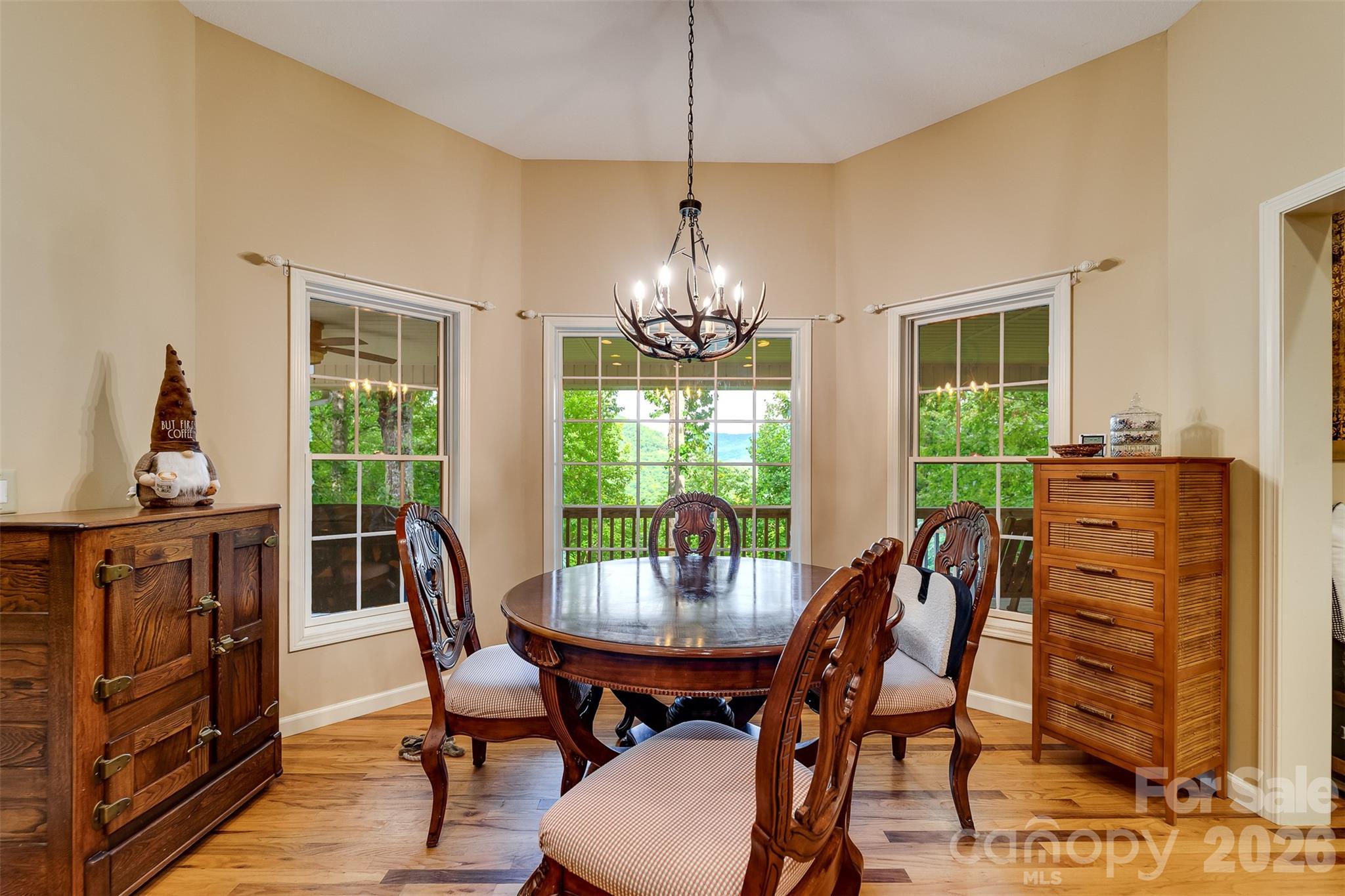 1838 Coman Road Franklin, NC 28734 - Photo 20 of 48 a dining room with furniture a chandelier and wooden floor