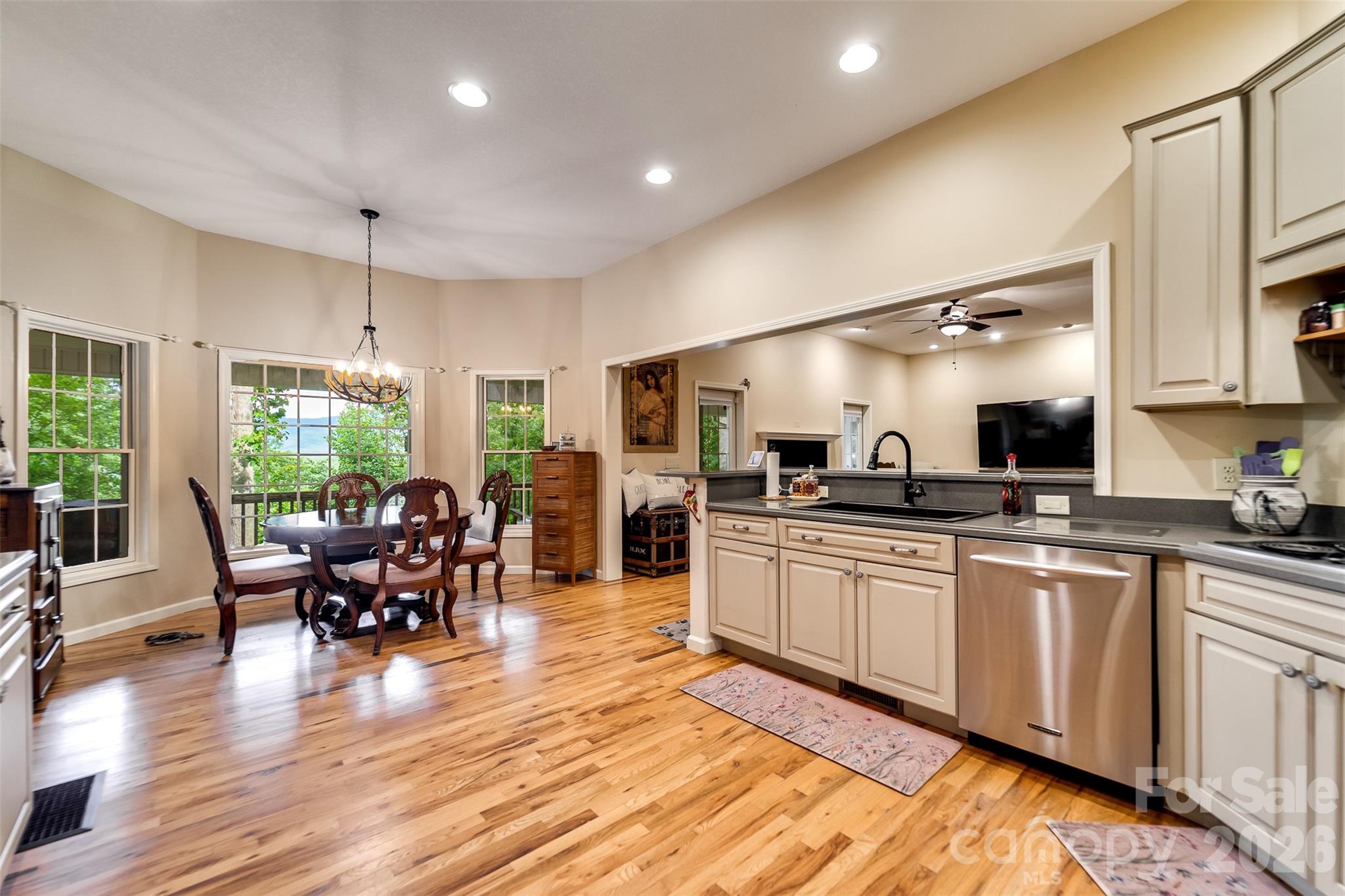 1838 Coman Road Franklin, NC 28734 - Photo 23 of 48 a kitchen with stainless steel appliances granite countertop sink stove and wooden cabinets