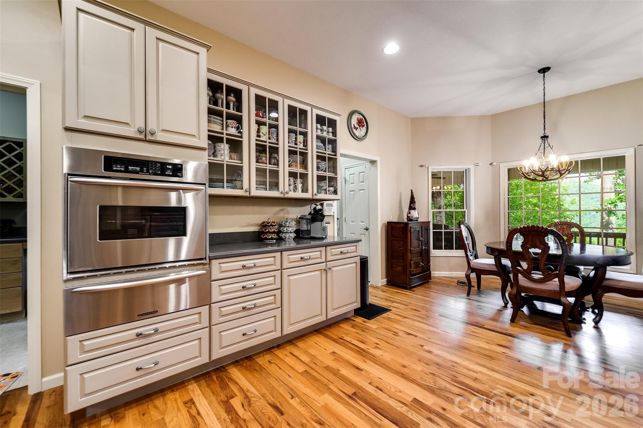 1838 Coman Road Franklin, NC 28734 - Photo 24 of 48 a kitchen with stainless steel appliances granite countertop a stove and white cabinets