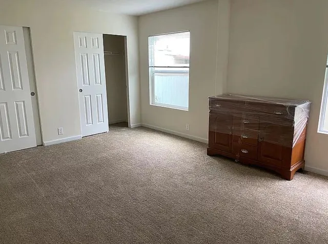 a view of an empty room with a window