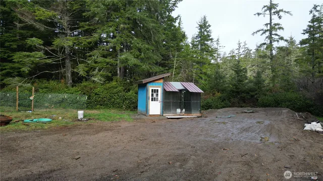 a view of a house with a yard and tree s