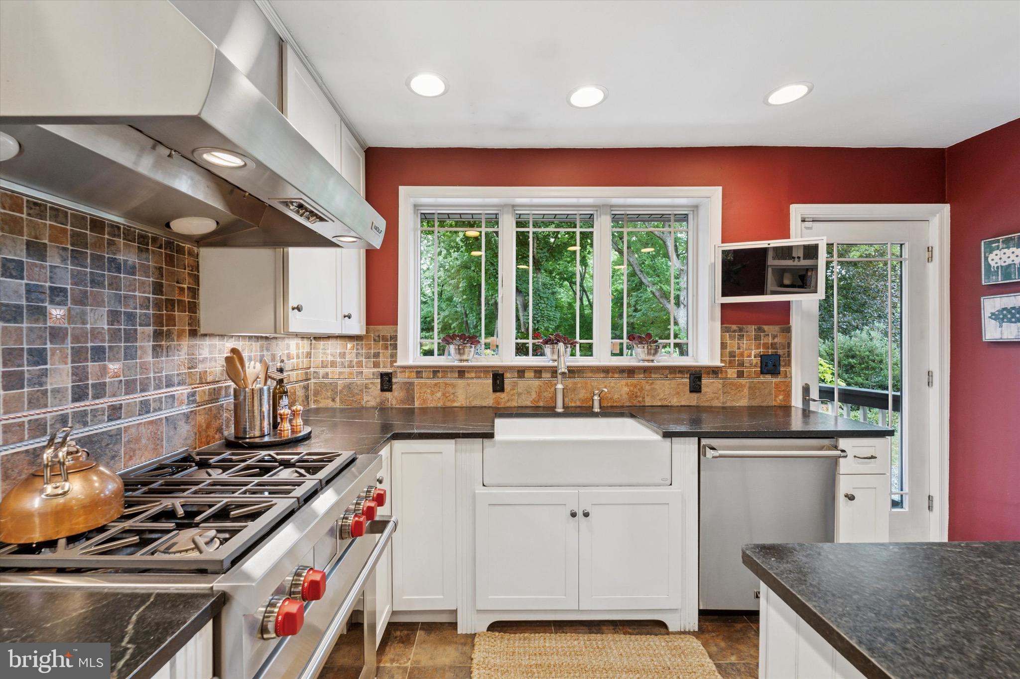 131 Brookmead Road Wayne, PA 19087 - Photo 5 of 28 a kitchen with a stove a sink a refrigerator and a counter top space