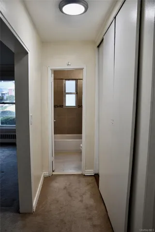 an empty room that has a wooden cupboard