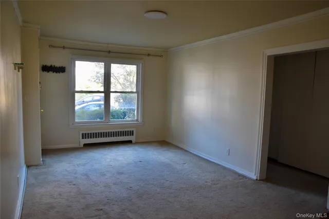an empty room with windows and ceiling fan